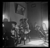 H. H. West's parents and daughters sit in the parlor of the West's house, Los Angeles, about 1909