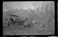 Al Schmitz, Elmer Cole and Charles Stavnow stand by H. H. West's Cadillac in their camp near Taboose Creek, Big Pine vicinity, about 1920