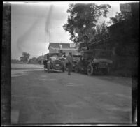 Al Schmitz standing by the cars, Mendocino County vicinity, 1915