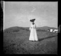 Hattie Morgan Whitaker posing in front of low hills, Los Angeles, about 1905