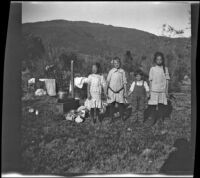 Irene Schmitz, Frances West, Chester Schmitz and Elizabeth West posing in the campsite near Silver Lake, June Lake vicinity, 1914