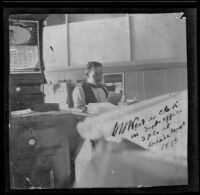 H. H. West sits at his desk in Frank E. Prior's office at the Arcade Depot, Los Angeles, 1898