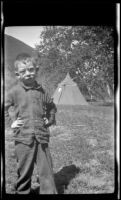 H. H. West, Jr. posing in front of the miner's tent, San Francisquito Canyon, about 1923