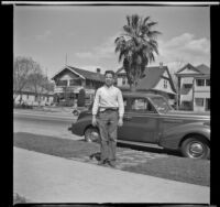 Richard Siemsen poses in front of H. H. West's Buick, Los Angeles, 1944