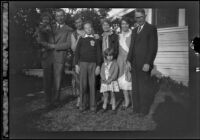 H. H. West's family poses in front of Wayne West's home, Santa Ana, about 1932