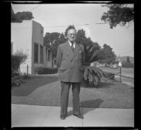 J. E. Smith poses on the front walkway outside his home, Los Angeles, 1943