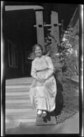 Mertie Whitaker sitting by the front porch of the West residence, Los Angeles, about 1915