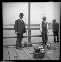George Corwin and Robert T. Brain stand on the wharf with their fishing gear, Santa Monica, about 1905