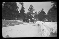 H. H. West's Buick and another car travel along a snowy road, Big Bear, 1932
