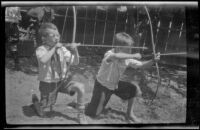 H. H. West, Jr. and Ambrose Cline aim their bows and arrows, Glendale, about 1924