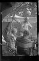 Mertie West and Agnes Whitaker sit on chairs while Forrest Whitaker stands next to them, Mammoth Lakes vicinity, 1940