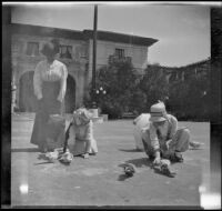 Frances West and Elizabeth West feeding pigeons in the Plaza de Panama while Minnie West watches, San Diego, [about 1915]