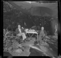 H. H. West and his brother-in-law, Forrest Whitaker, sit at a campsite, Toms Place, 1942