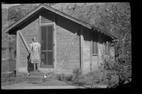 Mertie West on the porch of a cabin in Zion National Park, 1942