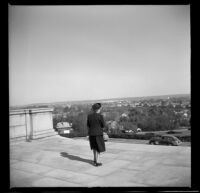 Mertie West exits the George Washington Masonic National Memorial and overlooks Alexandria, Alexandria, 1947