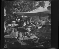 Josie Shaw, Mertie West, Forrest Whitaker and Agnes Whitaker sitting down to a meal in their camp, Mono County, 1941