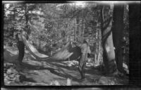 H. H. West (?) and Glen Velzy breaking up camp on the trip to Gardner Creek, about 1919