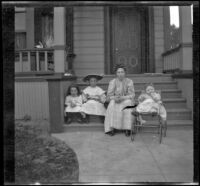 Mary West sits on the front steps of a house with her daughters, Elizabeth and Frances, as well as another girl, Los Angeles, about 1907