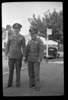 H. H. West, Jr. and Walter Burgess pose on the parkway outside H. H. West's home, Los Angeles, 1945