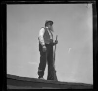 Worm's-eye view of Dad Smith standing on a train platform, Fontana vicinity, 1900