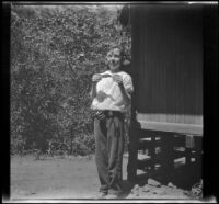 H. H. West, Jr. poses with the one and only fish he caught in Matilija Creek, Ojai vicinity, about 1925