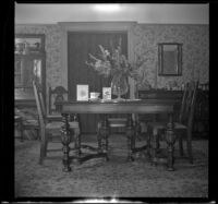 Vase of flowers, cards, and a mug that reads "Mother" on the West's dining room table, Los Angeles, 1943