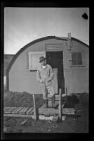 H. H. West, Jr. wears his field clothing and poses in front of his barracks, Dutch Harbor, 1943