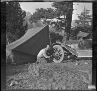 Glen Velzy works on H. H. West's Buick, Mammoth Lakes vicinity, 1915