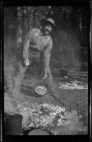 Sheep herder traveling with H. H. West and company shows off biscuits he made, Shasta County, 1917