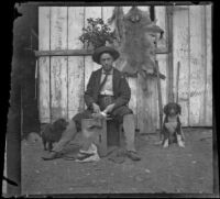 Bim Smith posing while cleaning a rabbit, Pomona, about 1895