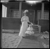 Lola Bidwell stands next to Elizabeth West who rides in a stroller, Venice, about 1903