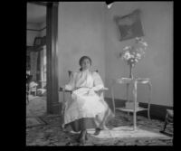 Neighbor's maid, Vicente, sits on a rocking chair in the West's parlor, Los Angeles, 1899