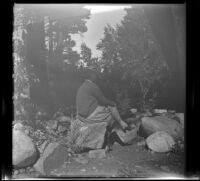 Agnes Whitaker sits on a rock, Toms Place, 1942