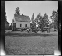 Three cars sit in the barnyard at John Bidwell's home, Burney Falls vicinity, 1917