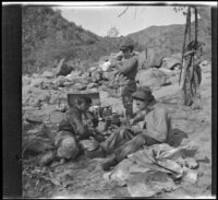 Winnie Scott, Cleo Swain and Mills Helen eating lunch near an outcrop of rocks, Los Padres National Forest vicinity, about 1917