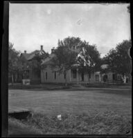 Home of the French family with trees and other houses surrounding it, Red Oak, 1900