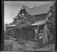 Ellen Lorene (Pinkie) Lemberger and Mrs. Rucher stand on a porch as John and Caroline Lemberger look on, Crafton, 1901