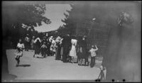 Visitors gather around an animal's cage at Stanley Park Zoo, Vancouver, 1947