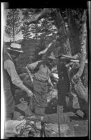 Charlie Stavnow and Glen Velzy breaking up camp on the trip to Gardner Creek, about 1919