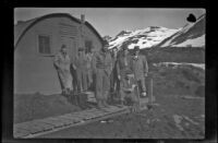 Eight unidentified servicemen pose outside H. H. West, Jr.'s quarters, Dutch Harbor, 1943