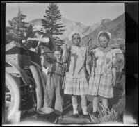 Elizabeth West, Frances West and Ted McClellan's son pose with fish, Mammoth Lakes vicinity, 1915