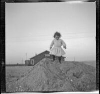 Elizabeth West walks on a pile of sand, Venice, about 1905