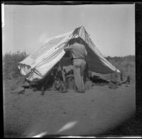 Dick Taylor stands at the entrance to the tent, San Diego County, about 1908