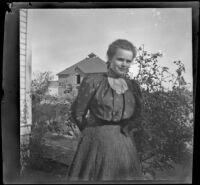 Alice Gordon poses in the side yard of the Lacy residence, Los Angeles, about 1900