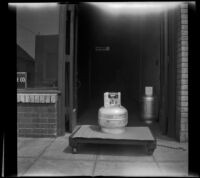 Gas tank sitting atop a dolly outside the H. H. West Company offices on Omar Avenue, Los Angeles, 1946