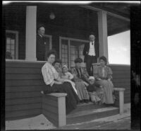 H. H. West's friends and family sit on the porch of his beach cottage, Venice, about 1903