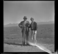 H. H. West and Mertie West pose along the roadside, Wells vicinity, 1942