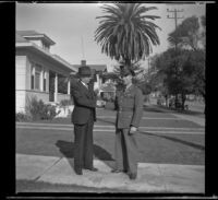 H. H. West and Gilbert Cecil West shake hands while standing on H. H. West's front walk, Los Angeles, 1941