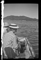 Agnes and Forrest Whitaker fish from a boat, Big Bear Lake, 1943