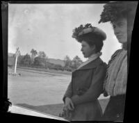 Ellen Lorene (Pinkie) Lemberger holds on to Mertie Whitaker's arm at a railroad station, Crafton, 1901